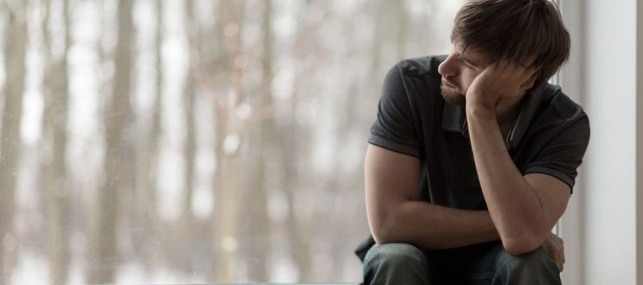 Man looking out at window with Depressed Conditions that Can Be Treated with Brainspotting