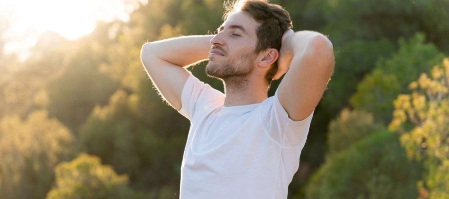 Image of a man outside enjoying Deep breathing exercises