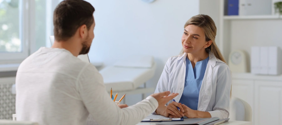 Physician sitting with patient and intently listening to him -  MAT for Long-Term Recovery from Alcohol