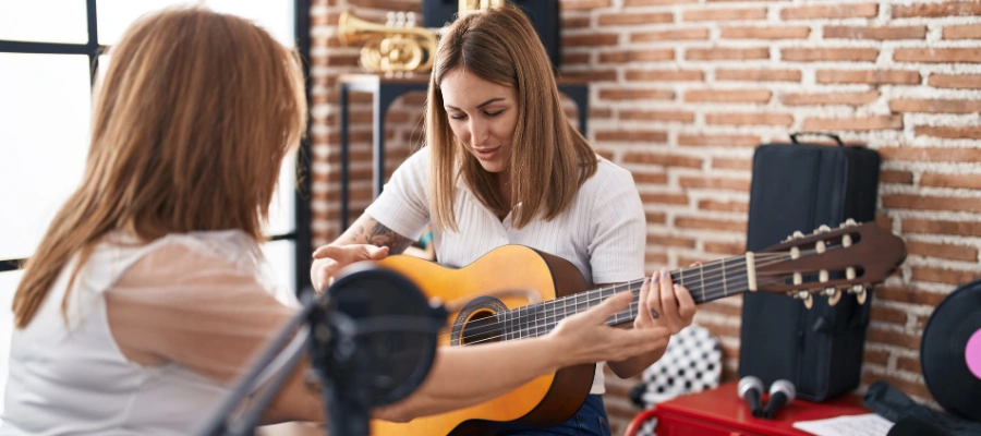 Patient Playing guitar in Music Class - Healing Beyond the Therapy Room