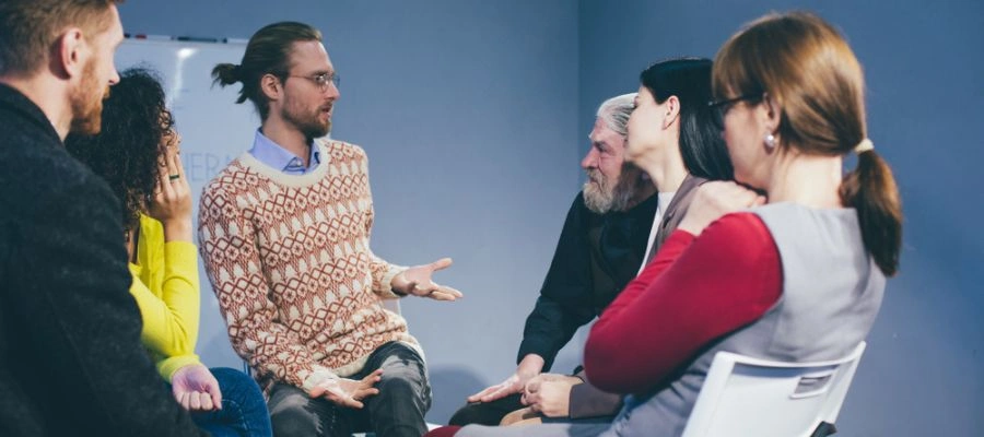 Image of men and women sitting in a circle at an NA meeting - NA meetings in Boise