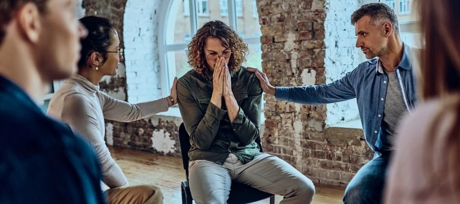 Image of men and women in a circle - Support Groups