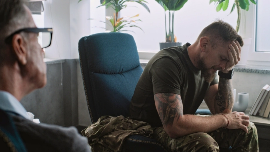 Image of a military man in anguish in consultation with his physician - Does TRICARE Cover Mental Health - Icarus Wellness and Recovery