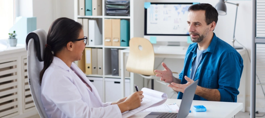 Image of a man talking his physician in a medically supervised detox for alcohol abuse