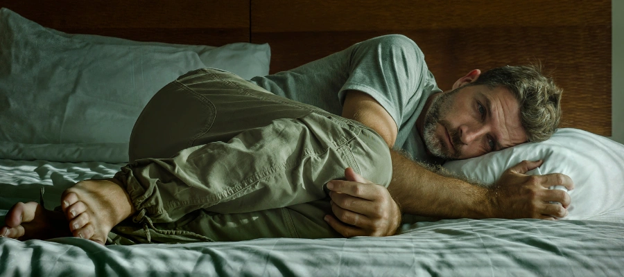Man struggling with sleep problems during 48–72 hours of meth withdrawal symptoms