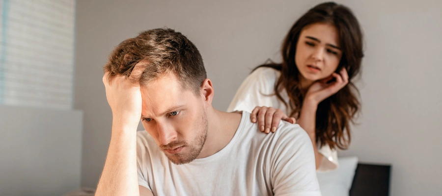 Woman trying to convince her abusive husband, reflecting the emotional conflict of being in a trauma bond