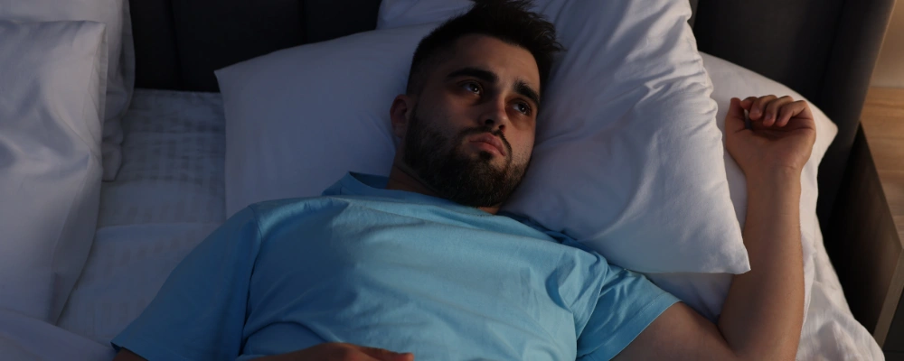 Image of a man awake late at night, showing disrupted sleep patterns from methamphetamine use