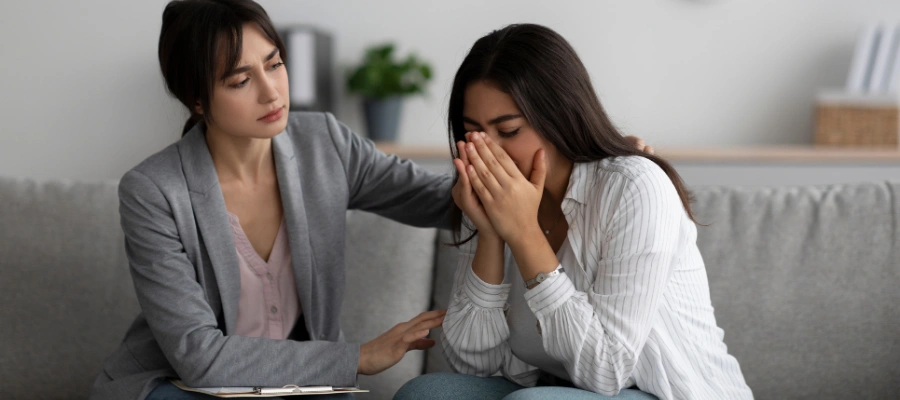 Image of a therapist providing trauma-informed counseling to support an adult survivor of childhood trauma