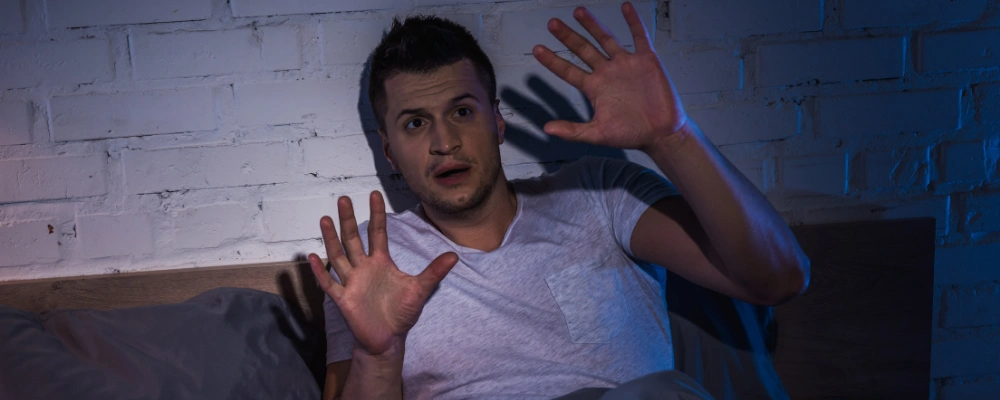 Person experiencing a flashback, overwhelmed by intrusive thoughts and anxiety from past trauma