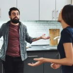 Image of a man holding a bottle of liquor in one hand having an unhappy conversation with with a woman beside him -Why an Alcoholic Cannot Love - Icarus Wellness