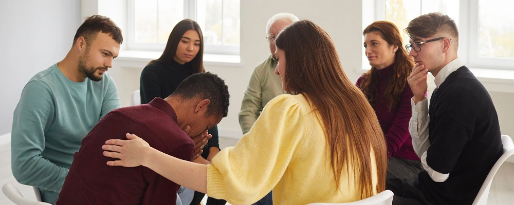 Image of Family sitting together in a supportive group meeting, representing Al-Anon and Alateen programs for families affected by addiction in Twin Falls, ID