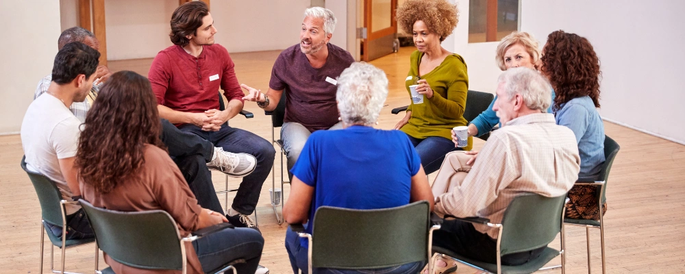 Image of a Group of people attending an AA meeting in Post Falls, Idaho for support and sobriety