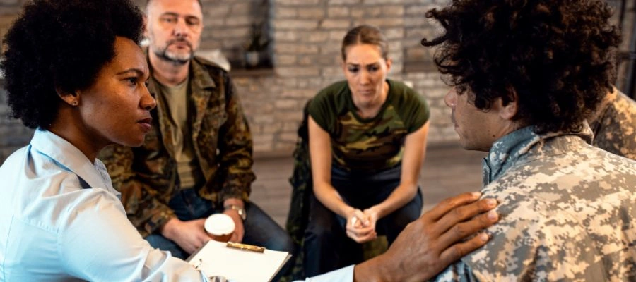 Image of a small support group meeting with people encouraging each other, representing community and recovery support for veterans and service members
