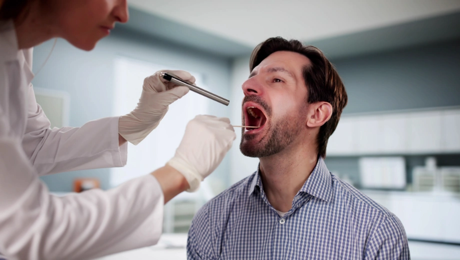 Image of a man receiving a saliva test from a technician - How Long Does Alcohol Stay in Saliva - Icarus Wellness and Recovery