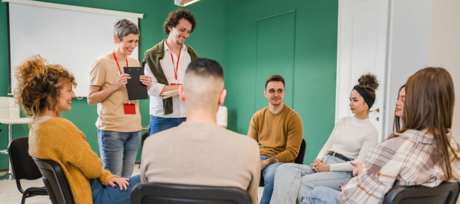 Image of a peer support group meeting where participants share experiences and build connection during trauma treatment