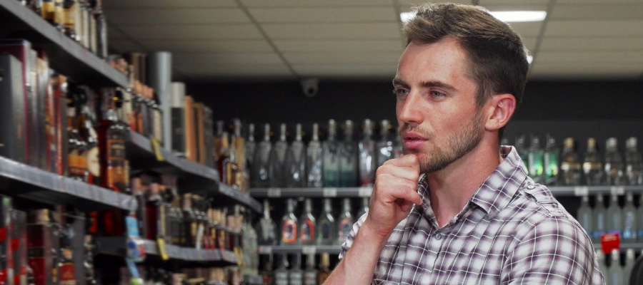 Image of a person looking at a store’s alcohol section