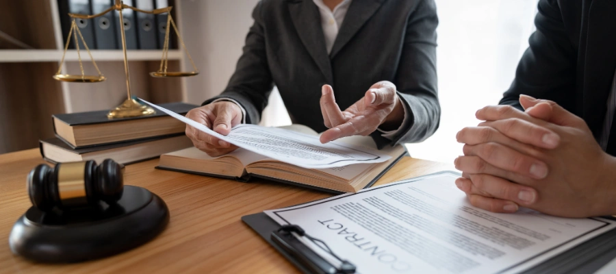 Image of a person reviewing Idaho legal documents about kratom regulations on a desk