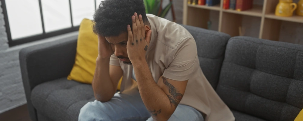 Image of a person holding head thoughtfully, symbolizing changes in brain chemistry linked to cannabis use