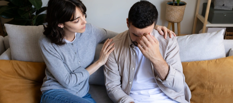 Image of a woman calmly supporting a loved one during his emotional distress