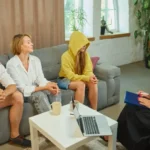 Image of a counselor and family members discussing nearby support groups for family members - Support Groups for Families of Addicts in Idaho - Icarus Wellness and Recovery