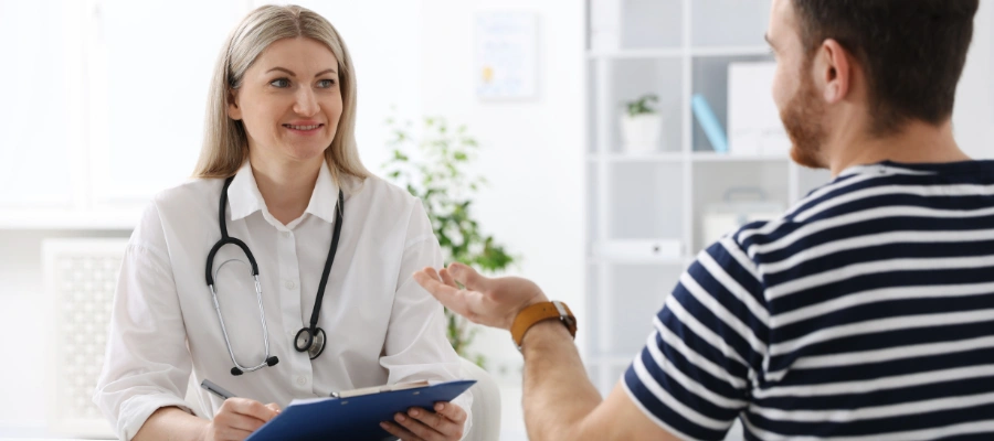 Image of a doctor and patient in consultation discussing dual diagnosis, age, and health conditions affecting detox and rehab needs