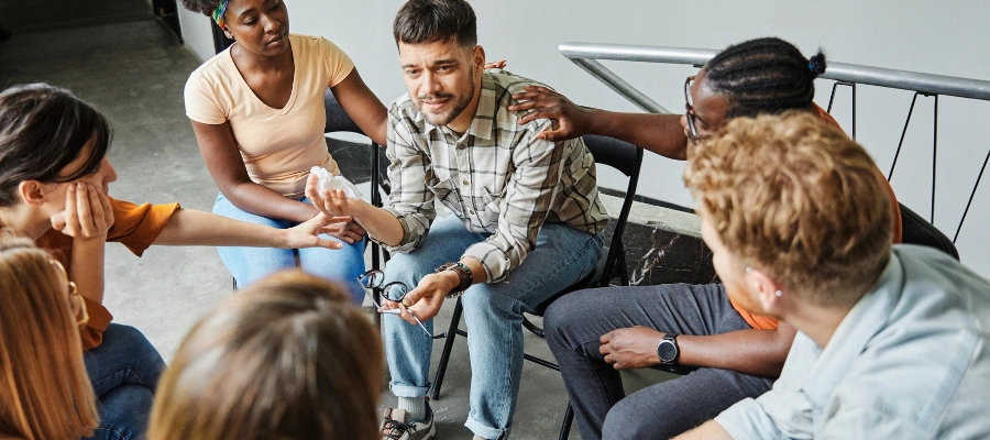 Image of a group of men in a peer support meeting demonstrating shared accountability and realistic relapse risk management together