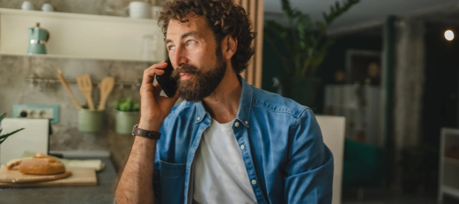 Image of a man on the phone reaching out to a recovery counselor or support person as a sign of strength following a relapse