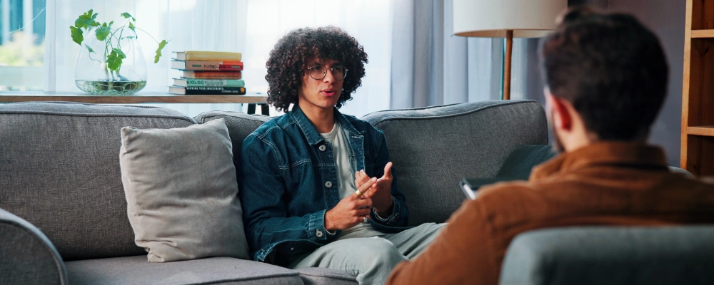 Image of a therapist and client discussing the measurable benefits and outcomes of music therapy in addiction treatment