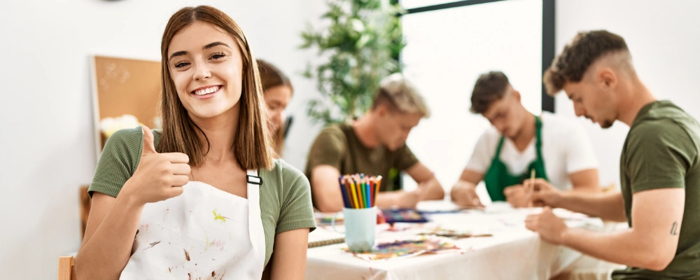 Image of young woman at art therapy smiling happy and positive