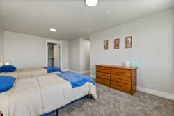 Twin-bed room with dresser and minimalist decor at Icarus Behavioral Health