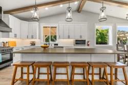 Kitchen island with bar stools and overhead lighting at Icarus Idaho