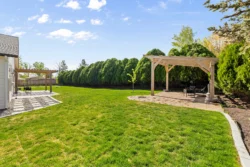 Green backyard space with privacy hedges at Icarus Behavioral Health